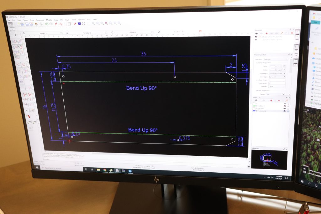 Computer Aided Design (CAD) being used on a desktop and showing a blueprint.