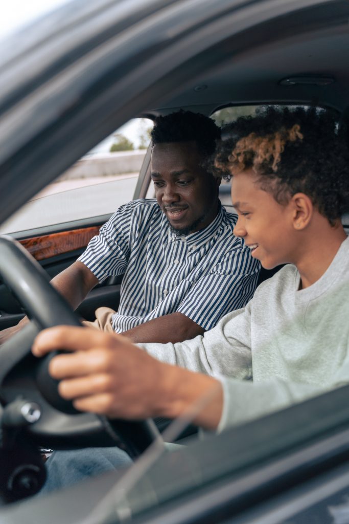 teenager learning how to drive a car