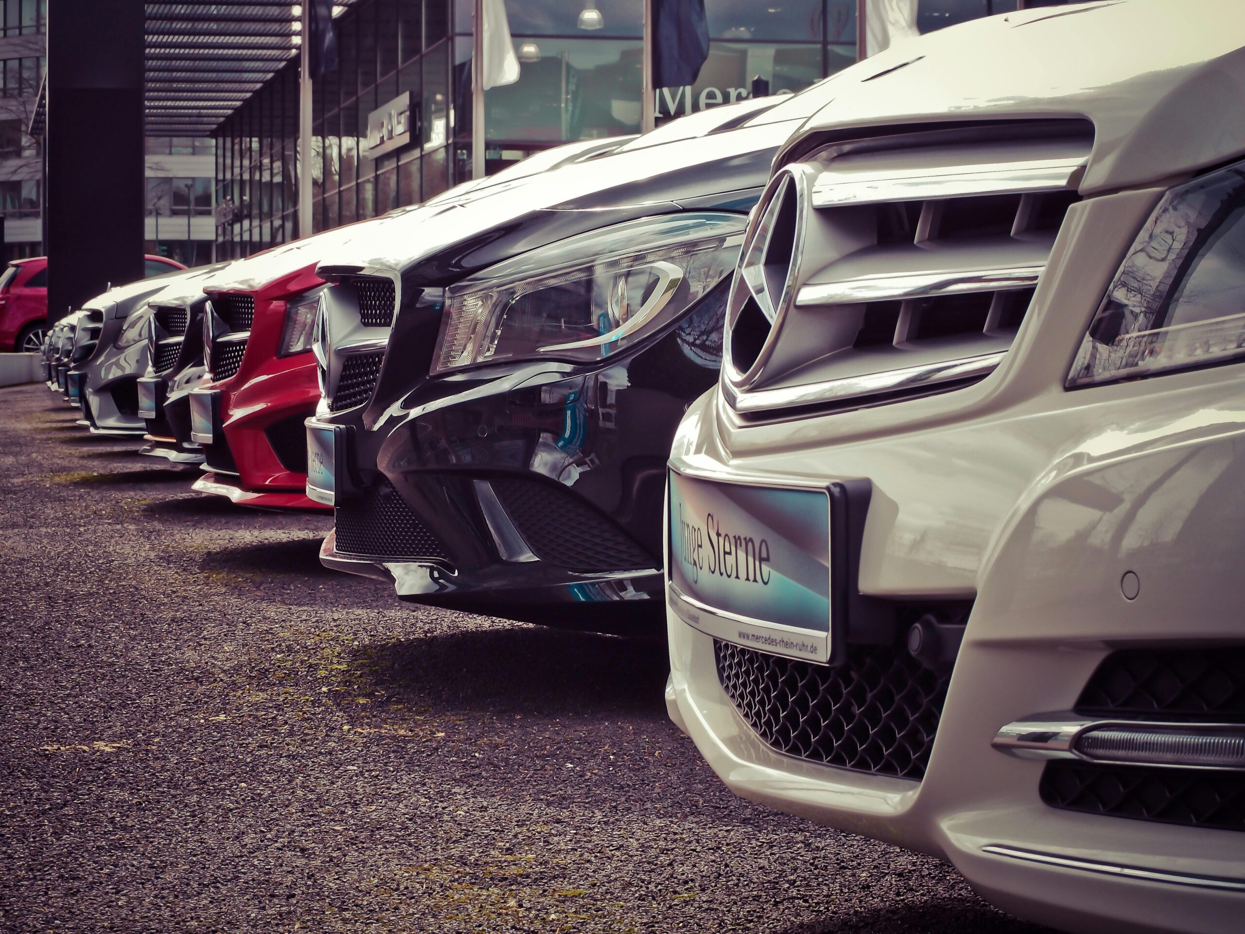 group of Mercedes cars in a line, colored white, black, and red, precision is key for automotive