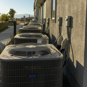 HVAC systems lined up against homes.